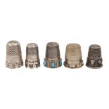 Five Continental silver thimbles, late 19th c and later, each with applied decoration, one with