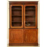 A Victorian mahogany bookcase, the upper part fitted with adjustable shelves enclosed by glazed