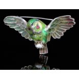 A French silver and enamel owlet brooch, early 20th c, with plique a jour wings, red stone eyes