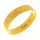 An 18ct gold wedding ring, London 1967, 2.4g, size L½ Slightly distorted and worn