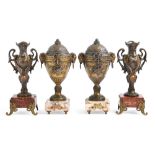 A pair of French fin de siecle patinated spelter neo classical style urns and covers with ram's head