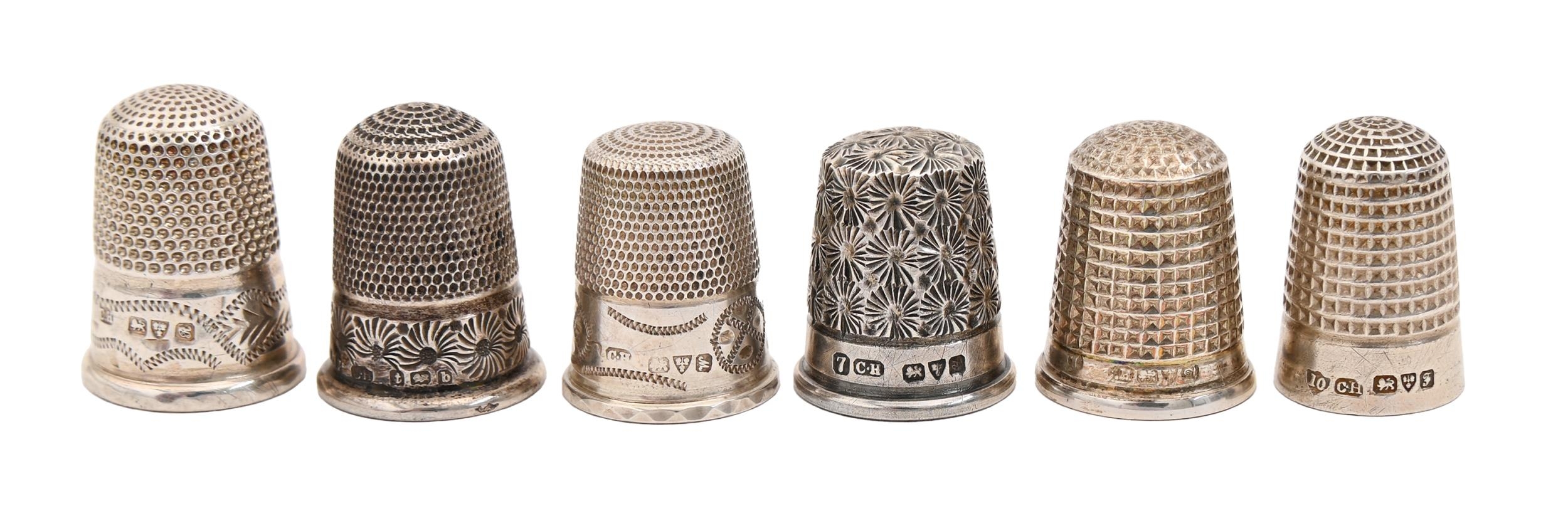 Six Edwardian and George V silver thimbles, one of Princess May pattern, various sizes, one