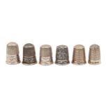 Six Edwardian and George V silver thimbles, one of Princess May pattern, various sizes, one