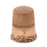 A gold thimble, late 19th c, applied with C scrolls alternating with flowers, 21mm h, 4g Good