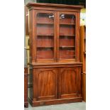 A Victorian mahogany bookcase, the upper part enclosed by glazed doors, the lower part by panelled