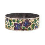 Bernard Instone. A silver and shaded champleve enamel napkin ring, with purple flowers on a primrose