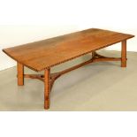 An oak hay rake table, in the manner of Ernest Gimson,  the three plank top with butterfly joints,
