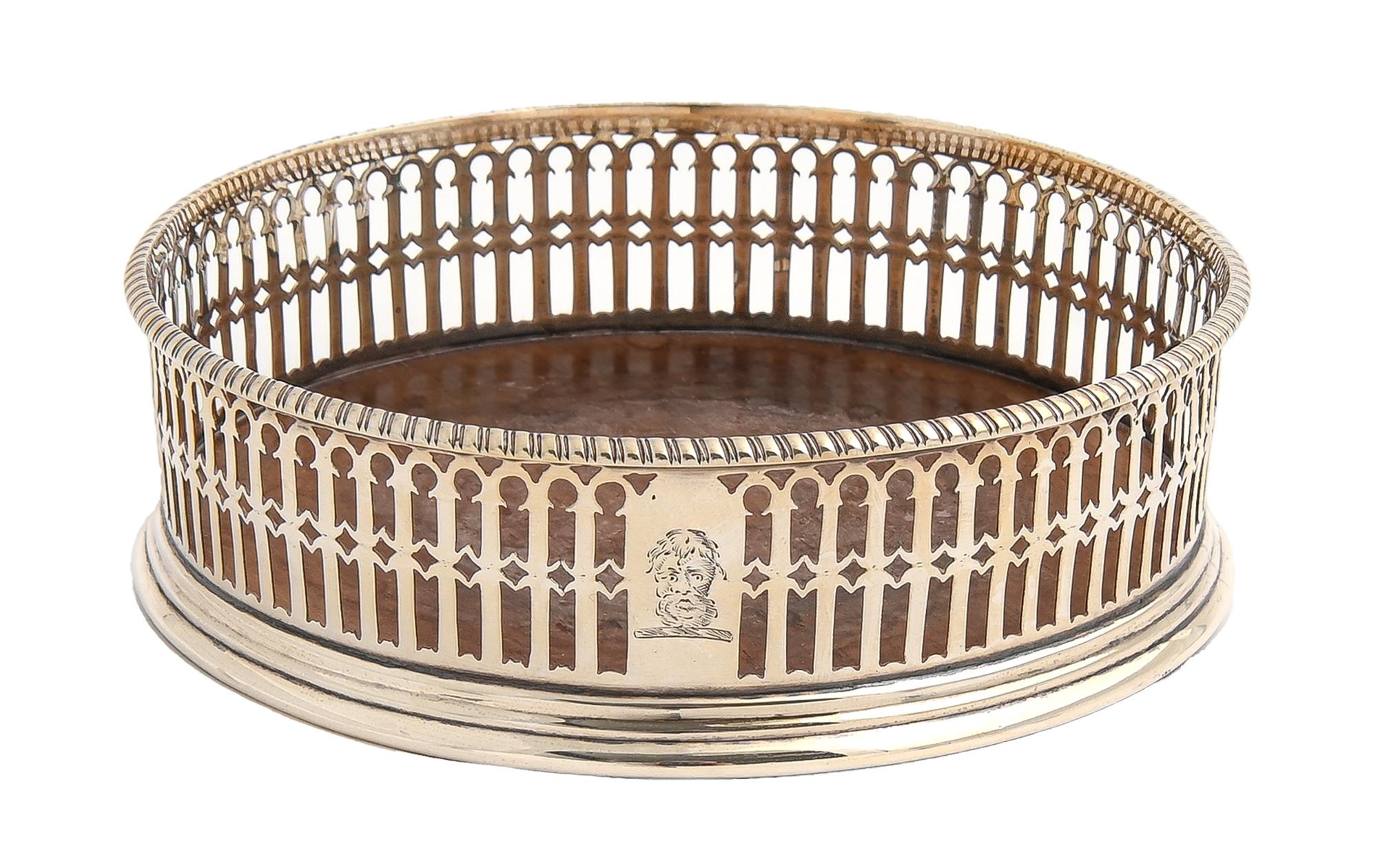 A George III pierced silver wine coaster, with gadrooned rim, wood base, crested, 12cm diam, marks