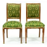 A pair of Charles X ormolu mounted mahogany chairs, with padded back,  in Empire style green
