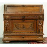 A Danish carved oak bureau, early 20th century, the lower part incorporating cupboards, the front