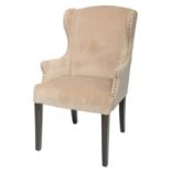 A close nailed beige plush wingback armchair in George III style