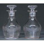 A pair of glass decanters and stoppers, first half 20th c, wheel engraved with band of grapevines,