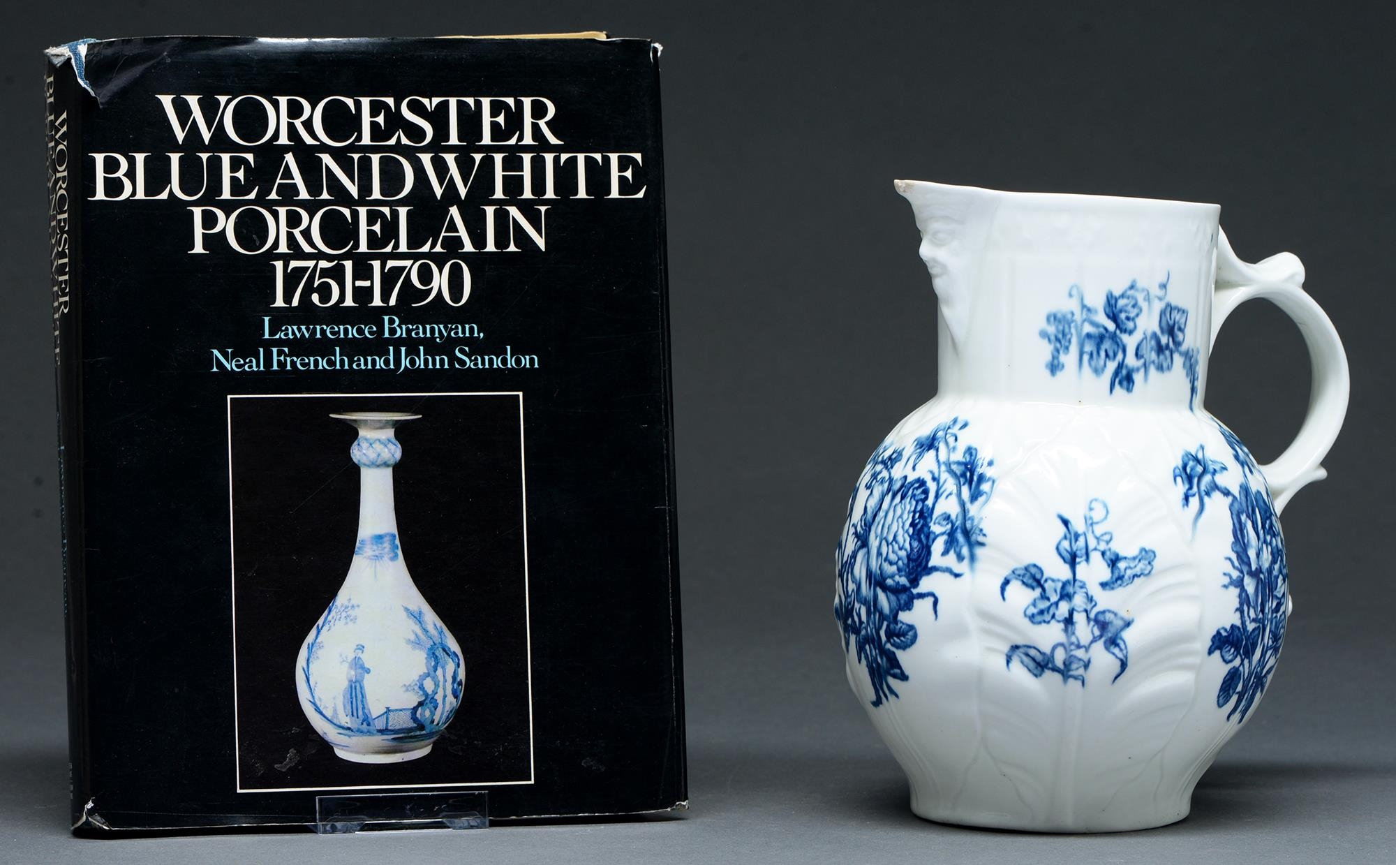 A Worcester blue and white cabbage leaf moulded mask jug, c1765-77, transfer printed with the