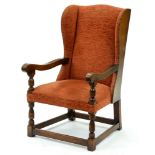 An oak wing armchair, second quarter 20th c, close nailed upholstery, seat height 43cm