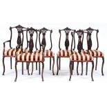 A set of six late Victorian carved mahogany dining chairs, James Shoolbred & Co, on cabriole legs,