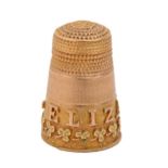 A Victorian three colour gold thimble, applied with the name ELIZABETH in red gold and a band of