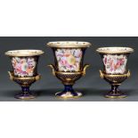 A Coalport garniture of three vases, c1820, painted in Worcester style with floral reserves on a