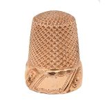 A gold thimble, late 19th c, with vacant cartouche and  band of spiralling foliage, 19mm h, 3.9g+
