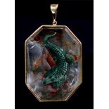 An octagonal carved and stained rock crystal crocodile intaglio, in an 18ct gold pendant, 32 x 44mm,