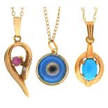 A ruby tear shaped openwork pendant, a cat’s eye pendant and a turquoise pendant, all in 9ct gold,