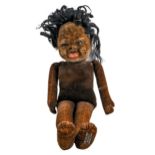 A Norah Wellings felt black doll, 1930s, with glass eyes, 42cm h, maker's cotton trade label under