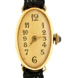 An oval gold lady's wristwatch, wire lugs, 25mm, marked 585 Apparently good condition, running