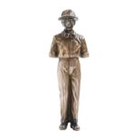 A silvered bronze statuette of a man, early 20th c, in helmet and goggles, 13.5cm h Good condition