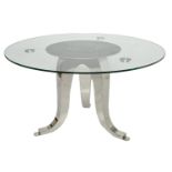 A contemporary polished metal centre table,  the round plate glass top on three upscrolled