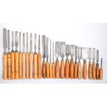 Twenty-seven Marples and other paring and firmer chisels and carving gouges, various wood handles