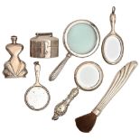 Three miniature silver hand mirrors, a magnifying glass, scent bottle, silver handled brush and