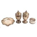 A pair of Victorian vase shaped silver pepperettes, an ashtray and a napkin ring, pepperettes 10cm
