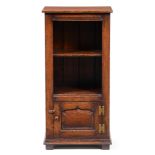 A Titchmarsh & Goodwin oak dwarf open bookcase, the ogee panel door to the lower part with brass H-