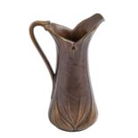 A naturalistic bronze jug, 20th c, cast with overlapping leaves, brown patina rubbed in places, 26cm