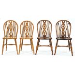 A pair of ash wheel back Windsor chairs and another pair of similar design Slightly marked