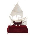 A miniature foreign silver model of a sailing vessel, 20th c, mounted on velvet covered plinth, 19cm
