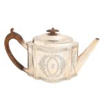 A George III silver teapot, engraved with festoons, the domed lid with integral joint, crested, 14cm