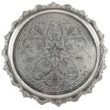 A Moroccan silvered metal tray or low table, on legs, 64cm diam
