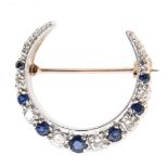 A sapphire and diamond crescent brooch, in 9ct white gold, 24mm diam, London date letter obscured,