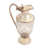 A Victorian silver mounted glass claret jug, of shield shape, engraved with festoons within beaded