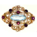 An aquamarine and garnet brooch, late 19th c, in gold, 50mm l, 11.2g Good condition