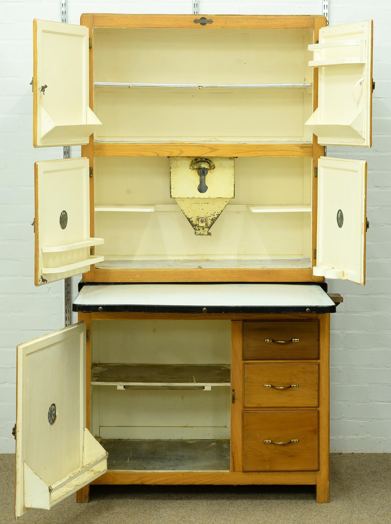 An early 20th c Hygena kitchen cupboard, with sliding enamelled work surface, the fitted interior - Image 2 of 2