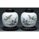 A pair of Chinese famille verte jars, 20th c,  painted with landscape, 12cm h, carved wood covers