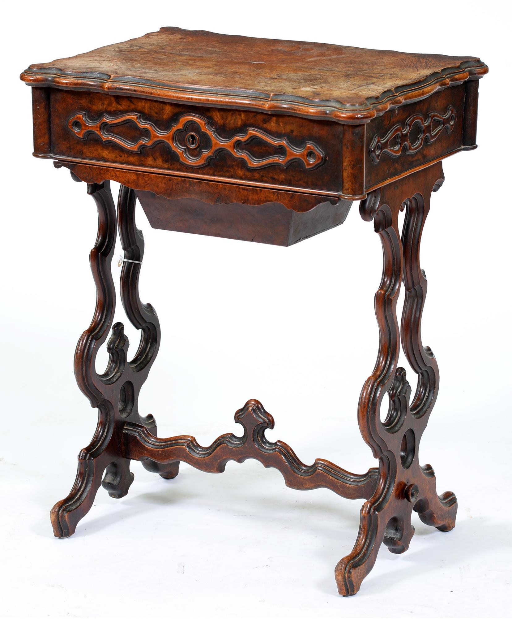 A Victorian serpentine walnut work table, the top in  quarter burr veneers, on pierced and moulded