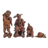 Three Japanese carved rootwood figures of immortals and a contemporary early 20th c Swiss limewood