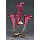 A Victorian plated wirework flower stand, c1900, retaining the four cranberry glass flower