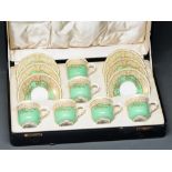 A set of six Royal Worcester apple green ground coffee cups and saucers, 1936, with gilt trellis