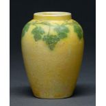 A Ruskin pottery jar, early 20th century, painted with vines on a mottled yellow lustre glaze,