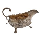 A Victorian silver sauceboat, in mid 18th c English style, chased with flowers and C-scrolls, 12cm