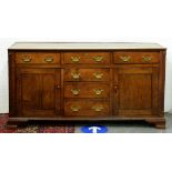 A George III oak dresser, North Wales, early 19th c, fitted with six drawers and enclosed by a