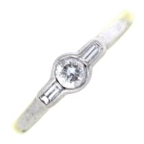 A diamond ring, the round brilliant cut diamond flanked by  baguette diamonds, in platinum, 5.8g,